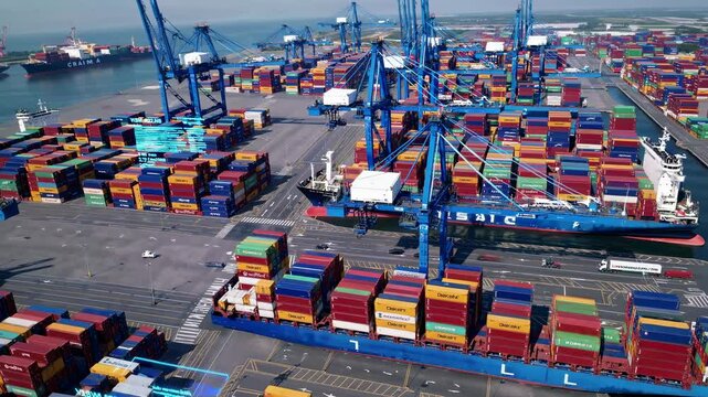 Aerial view of a bustling port with colorful shipping containers and cranes, capturing the dynamic flow of global trade in a video style.