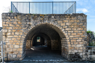 Building with arches and a bench next to the Lady of Kafr Bir’im Maronite Church at Bar'am National Park in northern Israel near the Lebanese border.
