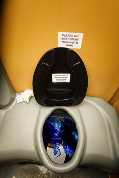 A public restroom toilet cubicle, a toilet at a reststop on a major road.