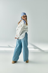 Stylish young woman showcasing spring fashion in a chic studio setting