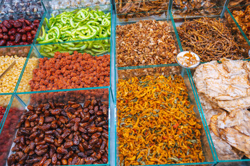 dried fish, seafood and sweet dried fruits on the counter of the Asian market in Vietnam