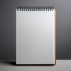 Minimalist close-up of an upright blank spiral notebook slightly open in a clean studio setting