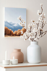 Minimalist interior decor with mountain art and white vase with cotton branches