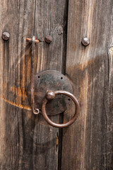 Rustic wooden door with an antique iron handle