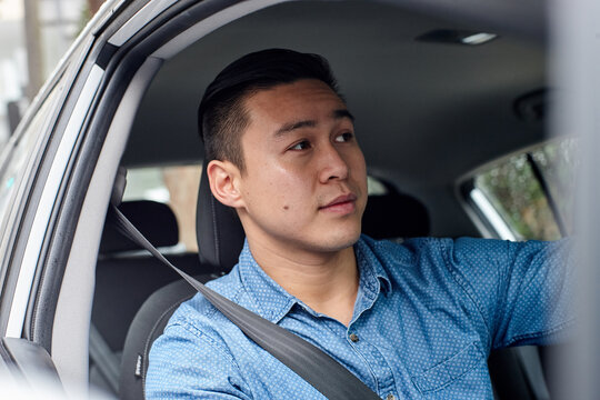 Asian man driving car