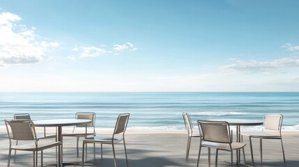 Outdoor cafe tables by the ocean; peaceful beach scene; ideal for relaxation; stock photography