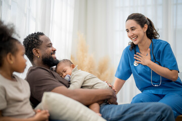 Healthcare professional interacts with family during check-up in cozy home setting
