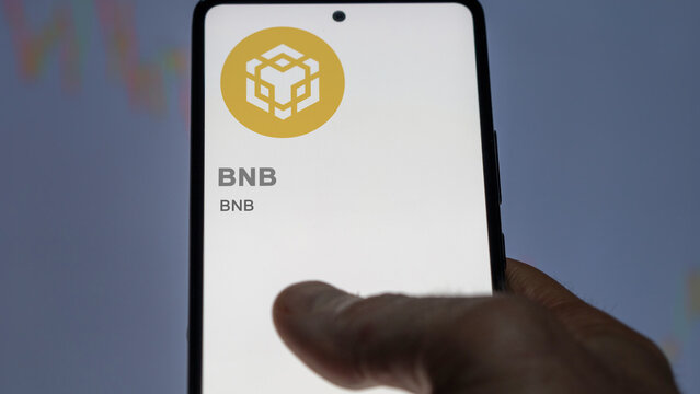 BNB, Close up on logo of BNB crypto asset on the screen of an exchange. Binance token price stocks, $BNB on a device.