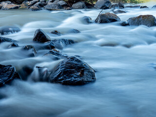 Serene River Flow with Rocks