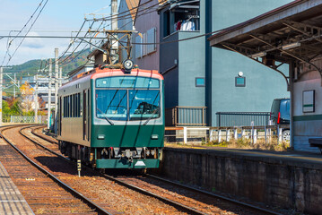 Obraz premium Local train arrive to railway station platform in Kyoto Japan. Train transportation concept.