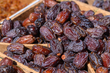 Sun-kissed dates showcased in a vibrant market during late afternoon hours, inviting passersby to indulge in their rich sweetness and health benefits