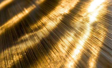 Abstract background of golden metal texture, light brown paper with a shiny surface and gradient, elegant golden wallpaper for design.