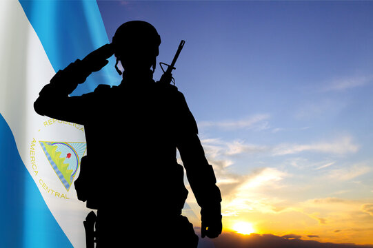 Silhouette of a soldier against the sunset with Nicaragua flag. National Holidays concept - Powered by Adobe