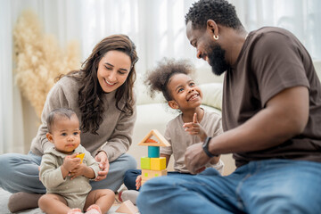 Family enjoying quality time playing with blocks in a cozy living room on a sunny afternoon