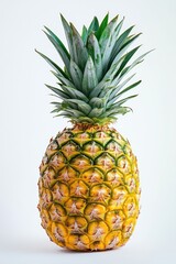 Fototapeta premium Whole ripe pineapple with green leaves standing on white background, fresh tropical fruit with bright color