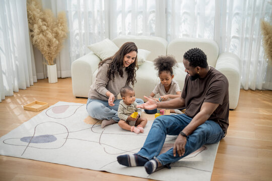Family enjoys quality time playing and bonding in a cozy living room on a sunny day