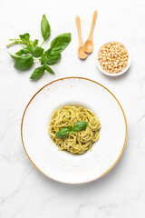 Italian pasta with pesto sauce and basil
