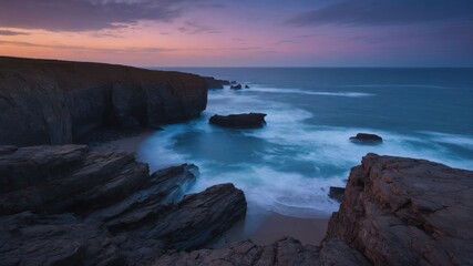 Serene coastal landscape at dusk with waves crashing against rocky cliffs.