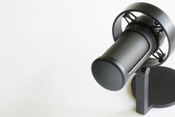 Podcast Microphone. A close-up of a high-quality podcast microphone with a shock mount, perfect for broadcasting, podcasting, and audio recording. Photo