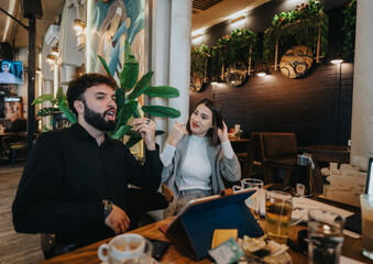 Colleagues engage in a lively conversation while connected digitally in a trendy cafe. The atmosphere is casual yet professional, reflecting modern work and social interactions in a relaxed setting.