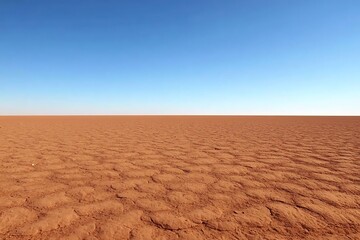 Expansive flat desert landscape under a clear and bright blue sky