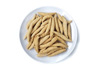 Kue telur gabus or Indonesian typical snack or cake on plate isolated on white background, Top view 