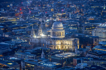 St Paul's Cathedral stands illuminated in the evening, showcasing its iconic dome amidst the...