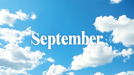 Sign of September against a bright blue sky with fluffy clouds.