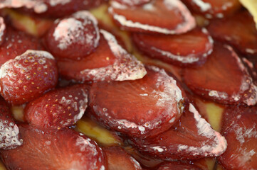 Layers of fresh strawberries atop a creamy dessert create a delightful summer treat enjoyed during sunny afternoons