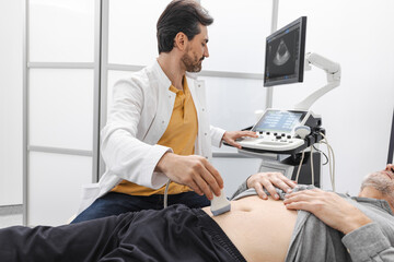 Ultrasound of prostate gland. Mature man getting ultrasound of prostate gland with sonography...