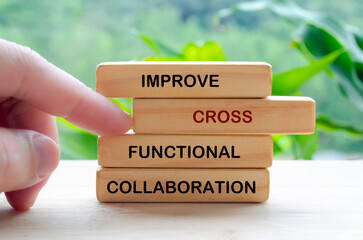 Improve Cross Functional Collaboration text on wooden blocks representing continuous improvement in...