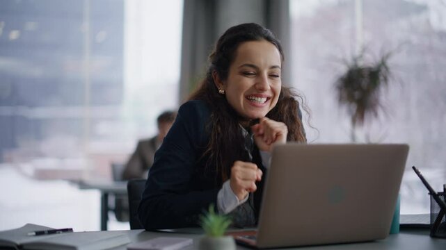 Online worker looking laptop reading good news at coworking work desk closeup