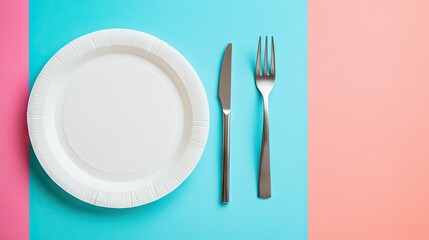 A top-down view of a white plastic disposable plate on a bright table setting, ready for use.