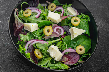 Salad with olives, cheese and green leaves fresh delicious gourmet food background on the table rustic food top view copy space keto and paleo diet vegetarian  food
