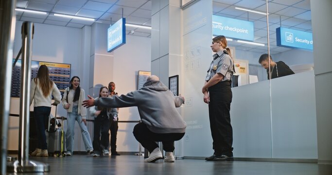 Emotional Family Reunion in Airport Terminal: Happy Man Greeting His Family Back From Vacation Trip, Lifts His Daughter in Arms. Diverse People Walking with Luggage for Boarding Flights. Slow Motion.