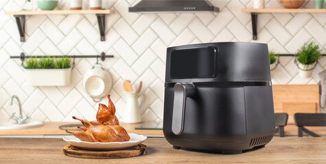 Baked quail air fryer oven in the kitchen. Long banner format. copy space