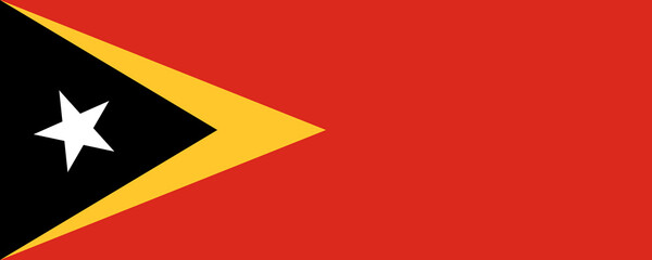 Flag of East Timor flying proudly in a bright blue sky during a cultural event on a sunny day