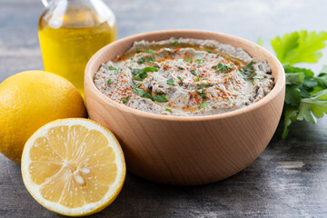 Traditional baba ganoush in bowl on wooden table