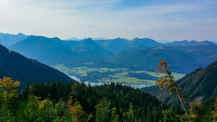 Stunning aerial view of Lake Wolfgang (Wolfgangsee) surrounded by lush green hills and scattered villages, captured from Schafberg mountain in Salzburg, Austria on clear day in idyllic Austrian Alps