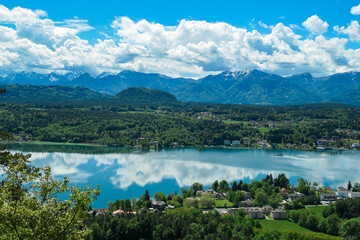 Panoramic view of Velden am W&ouml;rthersee, Carinthia, Austria. Serene W&ouml;rthersee lake, lush green landscapes, and surrounding hills and Karawanks mountain range, seen from the Hoher Kreuz viewpoint.