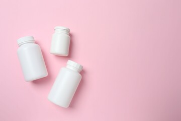 White bottles on color  background, top view