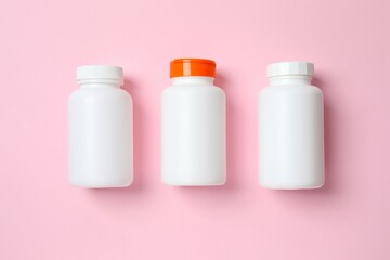 White bottles on color  background, top view