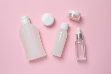 Natural cosmetic products on a pink background, top view