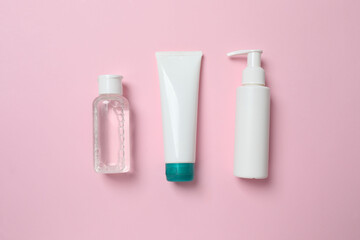 Natural cosmetic products on a pink background, top view