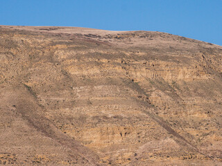 The rugged hills showcase layers of sandstone. Sandstone forms a stunning desert landscape