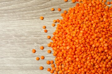 Red lentils on a wooden background
