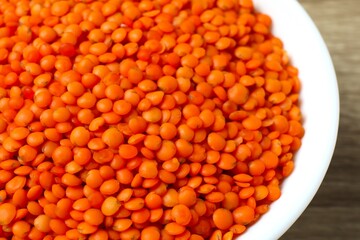 Red lentils on a wooden background