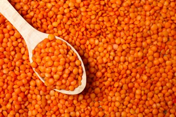 Red lentils on a wooden background