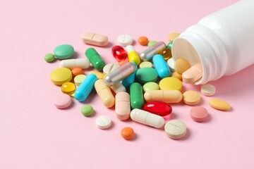 Various pills on color background, top view