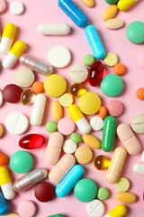 Various pills on color background, top view
